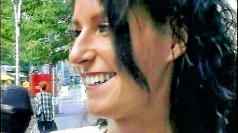 Smiling brunette in outdoor lesbian interview, close-up profile view