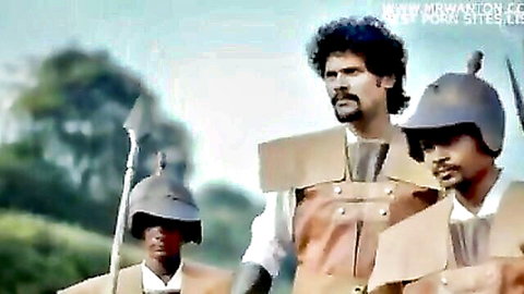 Three South Asian men in cardboard warrior armor posing outdoors with spears