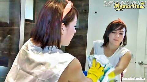 Petite brunette maid in sexy white dress cleaning bathroom mirror wearing yellow gloves