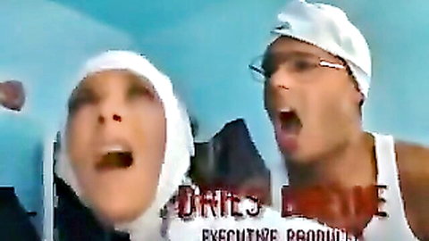 Intense nun in white habit and muscular man in swim cap yelling passionately