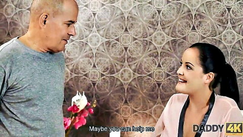 Young curvy brunette in robe chats with older bald man in Daddy4K age-gap scene