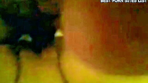 Blurry intimate scene with Soha Egypt in dim orange light, close faces