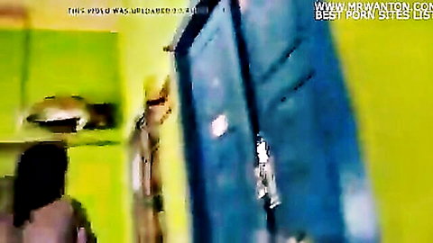 South Asian Indian woman in saree approached by man in uniform in green bathroom room