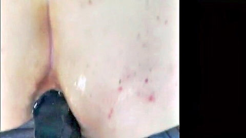 Close-up of submissive woman's anus with toy insertion and lube during masturbation