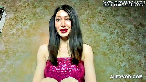 Hotkinkyjo in shiny pink top, deep cleavage, seductive pose