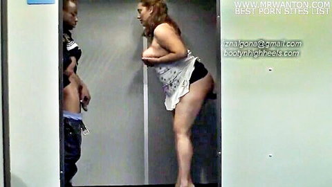 Curvy redhead with massive hanging tits and fat ass exposed bent over elevator wall for black guy grope