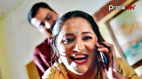 Indian aunty in yellow saree smiling on phone, mature desi beauty with man behind