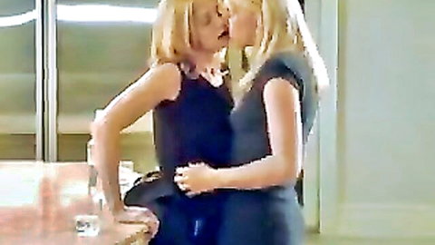Two blonde women passionately kissing in seductive embrace