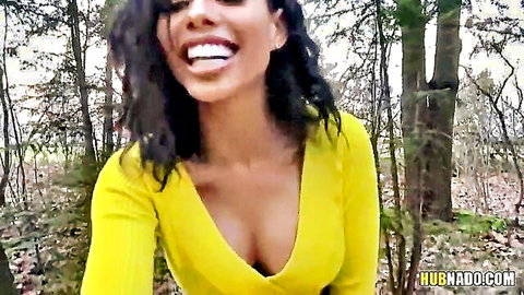 Busty smiling Latina shows massive cleavage in tight yellow top in forest