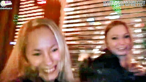 Two smiling blonde and redhead girls in Amsterdam nightlife, wild amateur fun