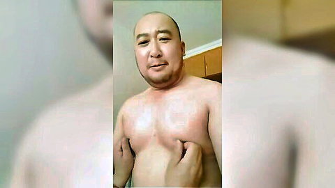 Chubby bald Chinese DILF pinching his puffy nipples shirtless in amateur selfie