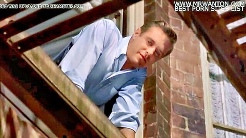 Handsome white man in white shirt peeking through window, voyeuristic thrill scene