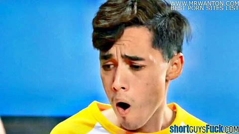 Young Latino guy in yellow shirt with wide open mouth shocked expression