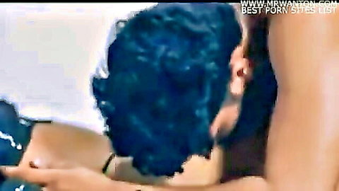 Blue-haired South Asian MILF passionately embraced by lover's arm around her neck in tight black top