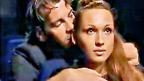 Intimate embrace of brunette woman and man in cinema, passionate neck kiss