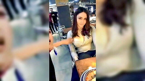 Curvy Latina in low-cut white top showing deep cleavage at table