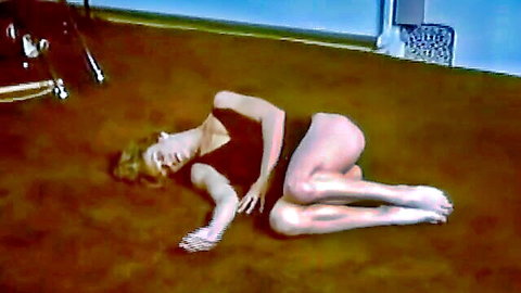 Retro blonde MILF in black leotard lying seductively on floor