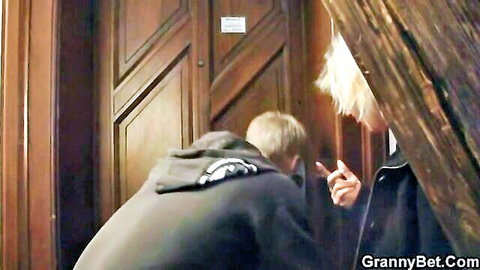 Mature blonde granny takes cock from behind in coat