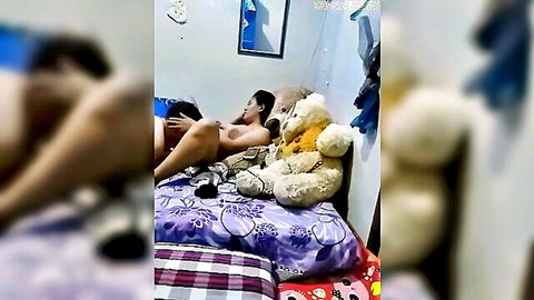 Nude Asian woman lying naked on bed with teddy bears, post-sex vibe