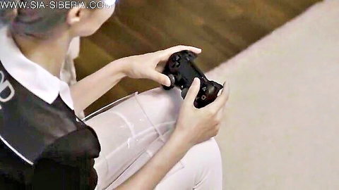 Sia Siberia as Kara from Detroit: Become Human, gamer girl cosplay sitting with PS4 controller