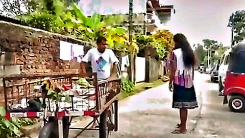 Sri Lankan couple in steamy outdoor kissing scene near market cart