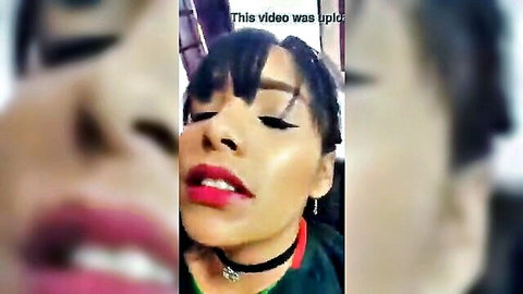 Smiling Latina woman with red lips and choker necklace close-up