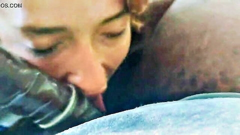 Cassie nuzzling black man's neck in steamy interracial embrace, redhead beauty up close
