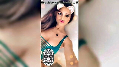 Brunette with cat ears in revealing green lingerie, teasing selfie