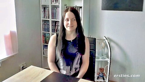 Emma E smiling intimately in black tank top, Ersties amateur solo