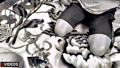 Asian woman kneeling in black shorts playing sex cards game with stepbrother