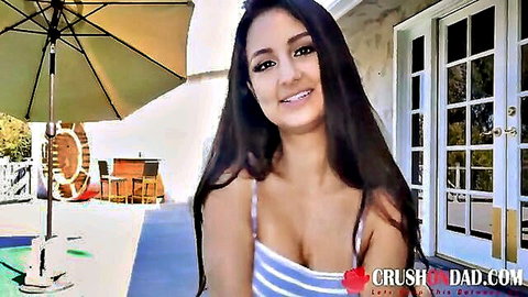 Eliza Ibarra smiling in low-cut striped tank top showing cleavage outdoors