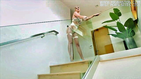 Skye Blue in sheer white lingerie posing seductively on stairs