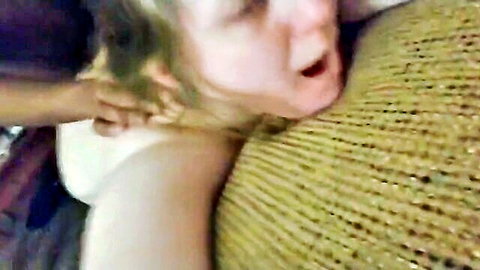 Blonde woman mouth wide open eyes rolling back as dark hand yanks her hair roughly