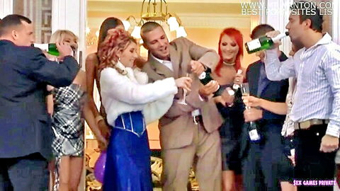 Sexy dressed-up babes and suited studs toasting champagne at luxurious party