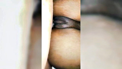 Close-up of ebony woman's big round ass and exposed pussy from behind