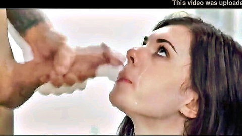 Brunette woman receiving intense facial cumshot close-up