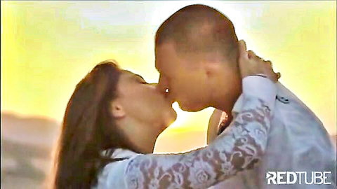 Passionate French kiss between curvy brunette MILF and handsome stud at sunset