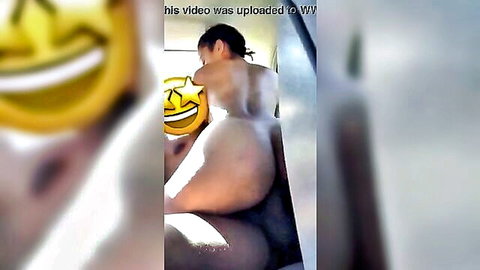Naked Asian woman bending over exposing bare ass and pussy in car