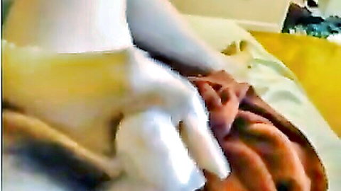 Indonesian couple steamy bedroom scene woman on yellow bed with hand on thigh