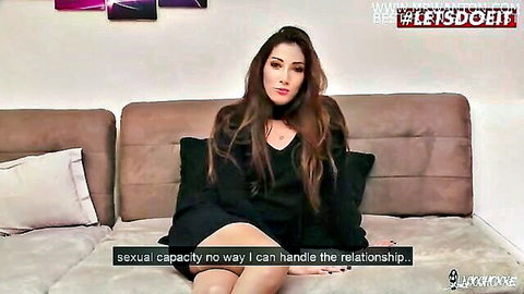 Clea Gaultier in black dress on couch, pondering relationships