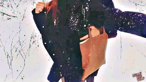 MollyRedWolf redhead in snowy winter coat and bag outdoors