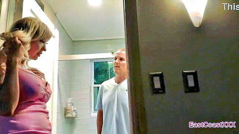 Victoria Lobov in low-cut pink dress teasing older neighbor in bathroom mirror