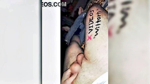 Blurry amateur close-up of hand on erect penis with thigh writing