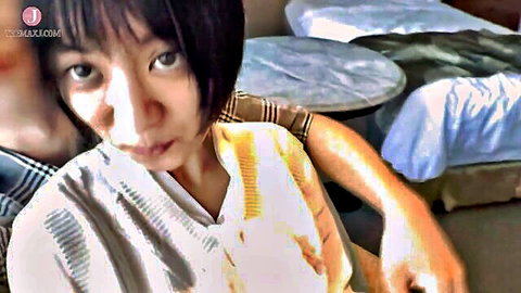 Asian woman with short black hair in light robe embracing man