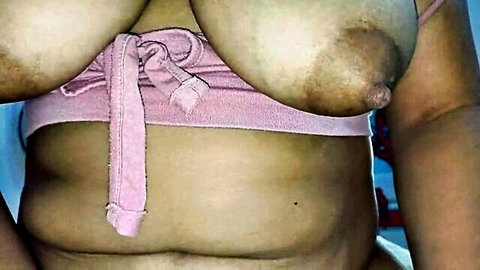 Busty Colombian wife topless in pink wrap, large natural breasts with dark nipples exposed
