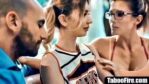 Blonde cheerleader teen and mature brunette in glasses flirt closely with bald bearded man in taboo threesome tease
