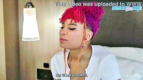 Pink-haired ebony babe in white top stares intensely, ready for rough fuck