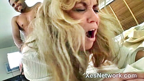 Blonde businesswoman rides big black cock in steamy interracial scene