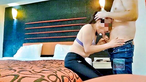 Busty woman in purple bra grabs man's big cock bulge over jeans in hotel room