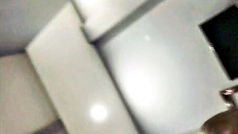 Blurry amateur hotel room scene with couple intimacy